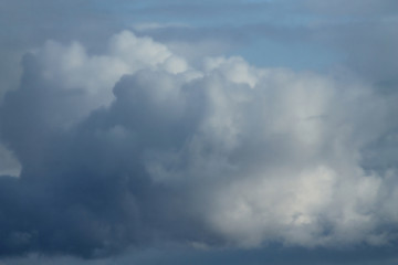 Obraz premium Cumulus white-gray clouds against the blue sky. Creative texture for background.