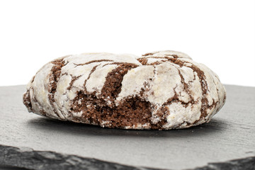 One whole baked chocolate brownie cookie on grey stone isolated on white background
