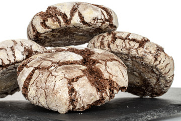 Lot of whole baked chocolate brownie cookie on grey stone isolated on white background