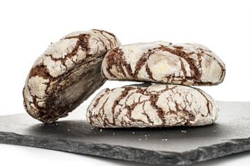 Group of three whole baked chocolate brownie cookie on grey stone isolated on white background