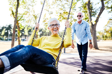 senior couple happy swing park love - obrazy, fototapety, plakaty