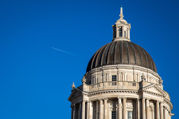 Fototapeta na wymiar An airliner flies over the Port of Liverpool Building at height in November 2013.