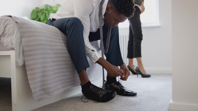 Business Couple In Bedroom Getting Ready For Work Businesswoman At Home Putting On Shoes 