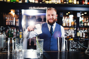 Cocktail at bar. Expert Bartender is making alcoholic cocktail.