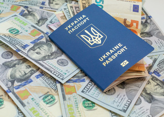 New biometric Ukrainian passport with electronic chip id.Free travel to Europe without visa.Close up shot of travellers document with paper US dollar currency