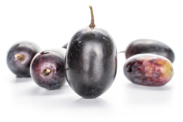 Group of five whole fresh black grape isolated on white background