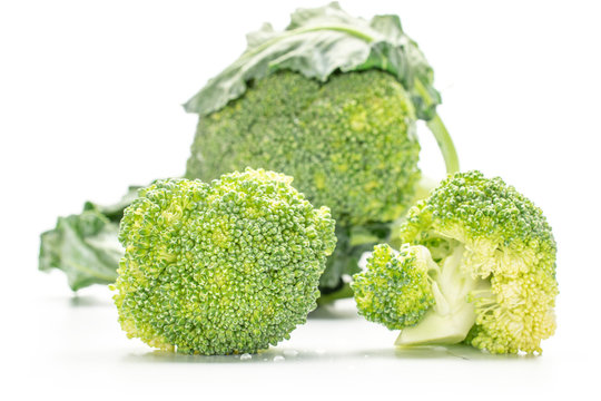 Group of three whole fresh green broccoli isolated on white background