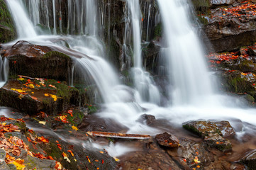 Mountain waterfall in autumn forest
