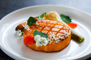 Roast pumpkin dish with leek and garlic flowers