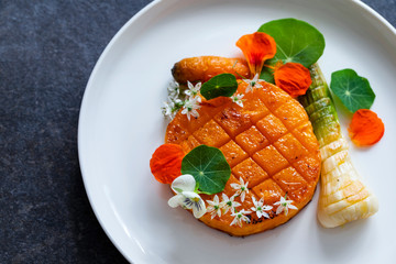 Roast pumpkin dish with leek and garlic flowers