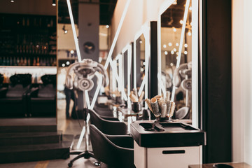 Interior of modern and fashionable hair salon. - obrazy, fototapety, plakaty