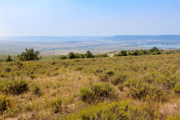 Hilly landscape with sparse vegetation.