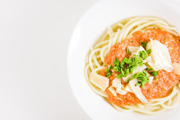 Italian pasta with tomato sauce, parmesan cheese, fresh oregano - on white background.