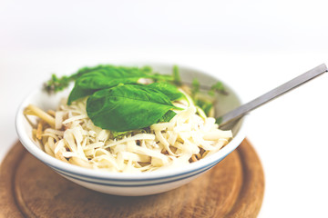 Italian pasta with tomato sauce, parmesan cheese, fresh oregano - on white background.
