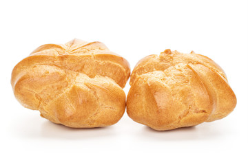 Group of two whole baked golden profiterole isolated on white background