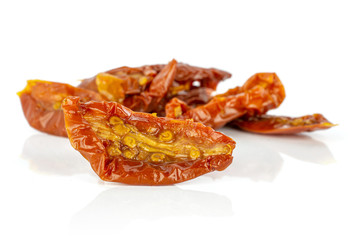 Lot of slices of dry red cherry tomato front focus isolated on white background