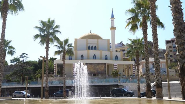 DURRES, ALBANIA, August, 2019: Fountains in park and mosque in Durres city