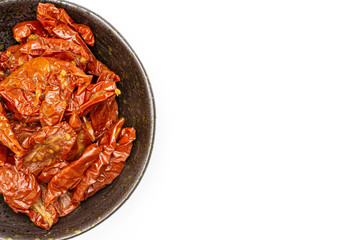 Lot of slices of dry red cherry tomato copyspace on grey ceramic plate flatlay isolated on white background