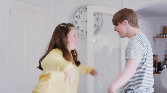 Young Downs Syndrome Couple Having Fun Dancing At Home Together