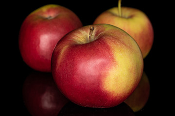 Group of three whole red apple jonagold isolated on black glass