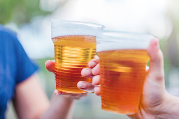 Friends enjoying drinking beer in the backyard.