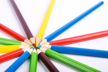 Naklejka premium Many different colored pencils on a white background with a place for text and cory space .