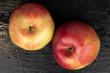 Group of two whole red apple jonagold flatlay on grey stone