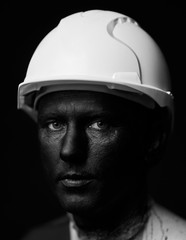 Coal and Oil Miner, dirty worker against dark background, close-up