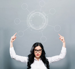 Tech circle with business woman pointing upwards on a gray background
