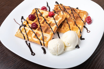 Viennese waffles with ice cream, chocolate and cherry.
