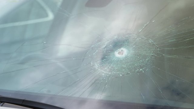 Detail Of Damage To Windscreen Of Car Shattered By Vandalism
