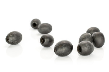 Group of nine whole disordered tasty black olive isolated on white background