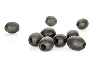 Group of nine whole disordered tasty black olive isolated on white background