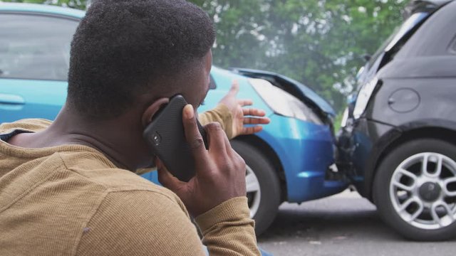 Male Driver Involved In Car Accident Calling Insurance Company From Roadside