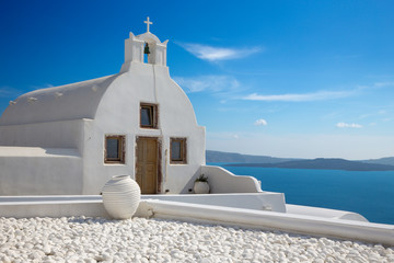 Santorini - The look to little white church in west part of Oia over the caldera.