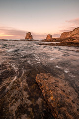 Two Sisters of Hendaye with beautiful sunset sky, vertical photography. France