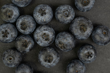 Lot of whole fresh blue blueberry heap flatlay on grey stone