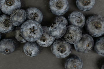 Lot of whole fresh blue blueberry heap flatlay on grey stone