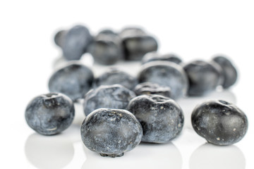 Lot of whole disordered fresh blue blueberry isolated on white background
