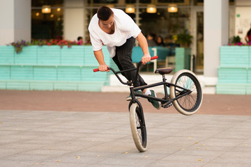 The guy on the stunt bike does the twist of the wheel and does the stunts on the front wheel.