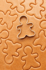 Gingerbread men cookies background. Christmas baking texture with cutter