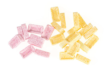 Lot of whole disordered sweet pastel candy flatlay isolated on white background