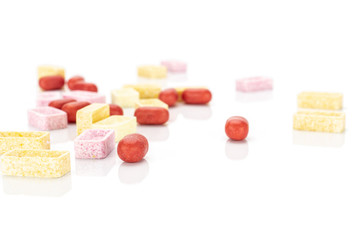 Lot of whole disordered sweet pastel candy isolated on white background