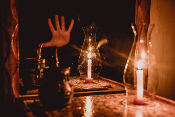 glass of wine and candle on black background