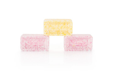 Group of three whole sweet pastel candy isolated on white background
