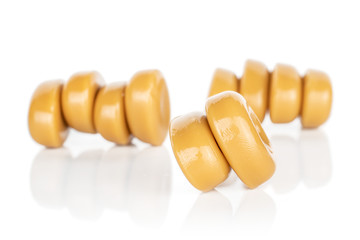 Lot of whole caramel brown candy front focus isolated on white background