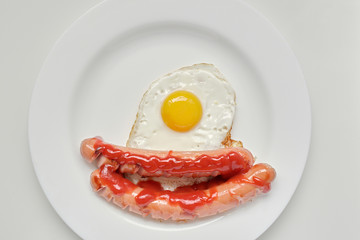 Fried egg and two sausages for healthy breakfast