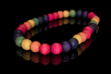 Lot of whole wooden bead  circle isolated on black glass