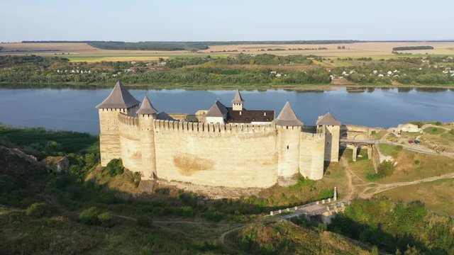 Aerial view of old castle near the River. Hotyn Castle in Ukraine. Eastern Europe. Tracking from right to left.