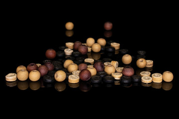 Lot of whole wooden bead stack isolated on black glass